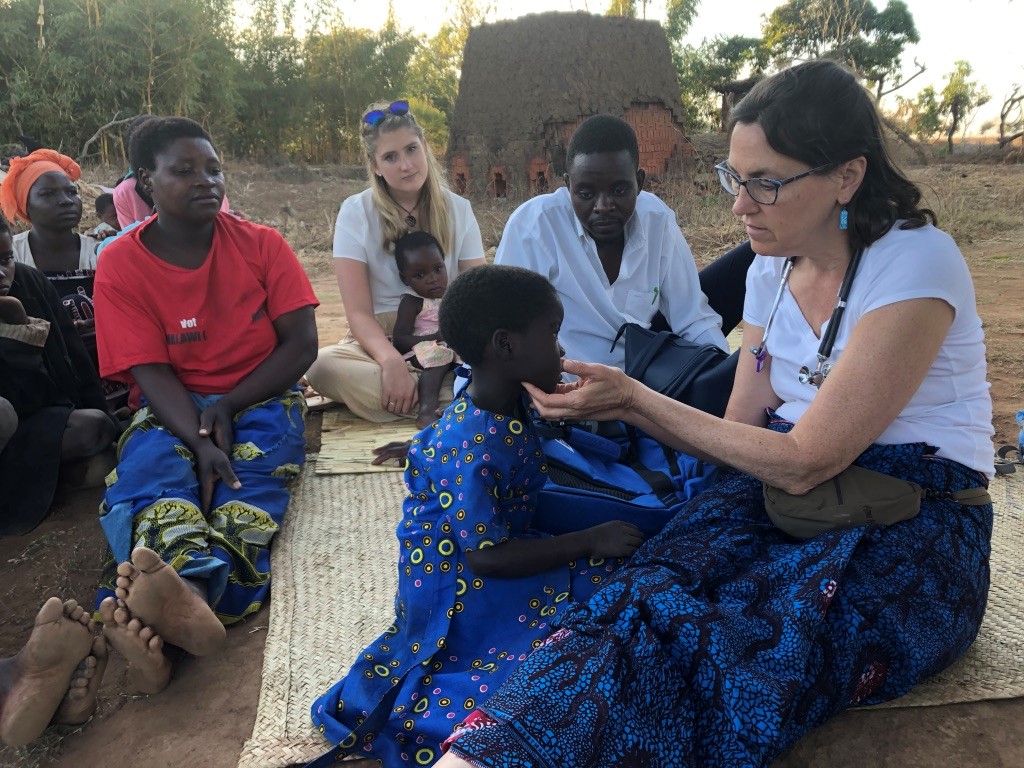 Dr. Barbara R Edwards, Princeton internist, taking care of a sick child in Malawi