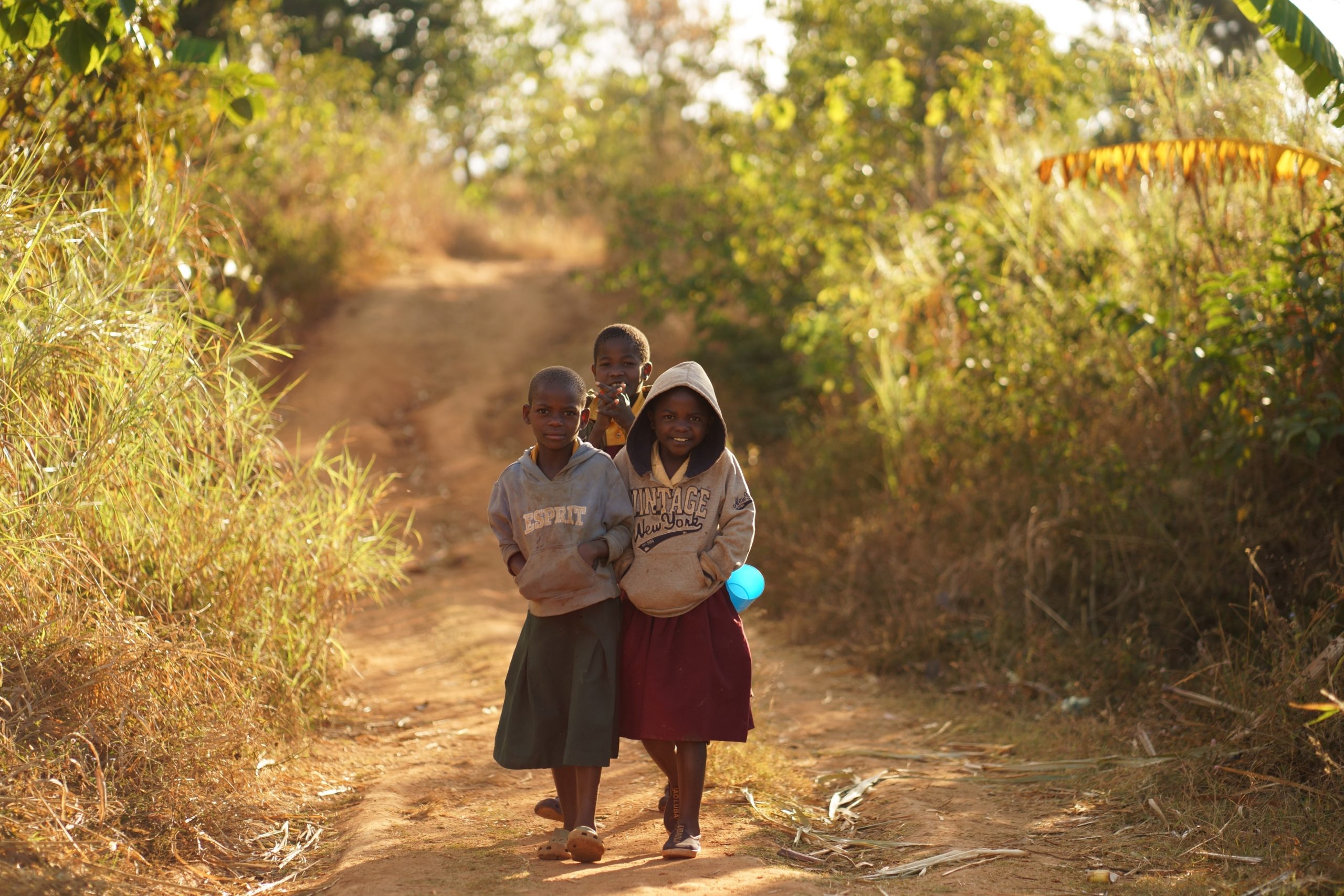 the children of Malawi walking down a dirt road towards Dr. Barbara Edwards Princeton