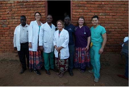 Dr. Barbara Edwards, Princeton internist, standing with a group of doctors in Malawi