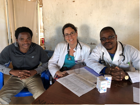 Dr. Edwards, Princeton Internist, sitting with the doctors of Malawi