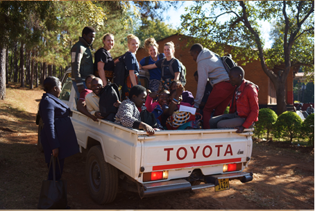 A group of volunteers in Malawi in the back of a truck with Dr. Barbara R Edwards