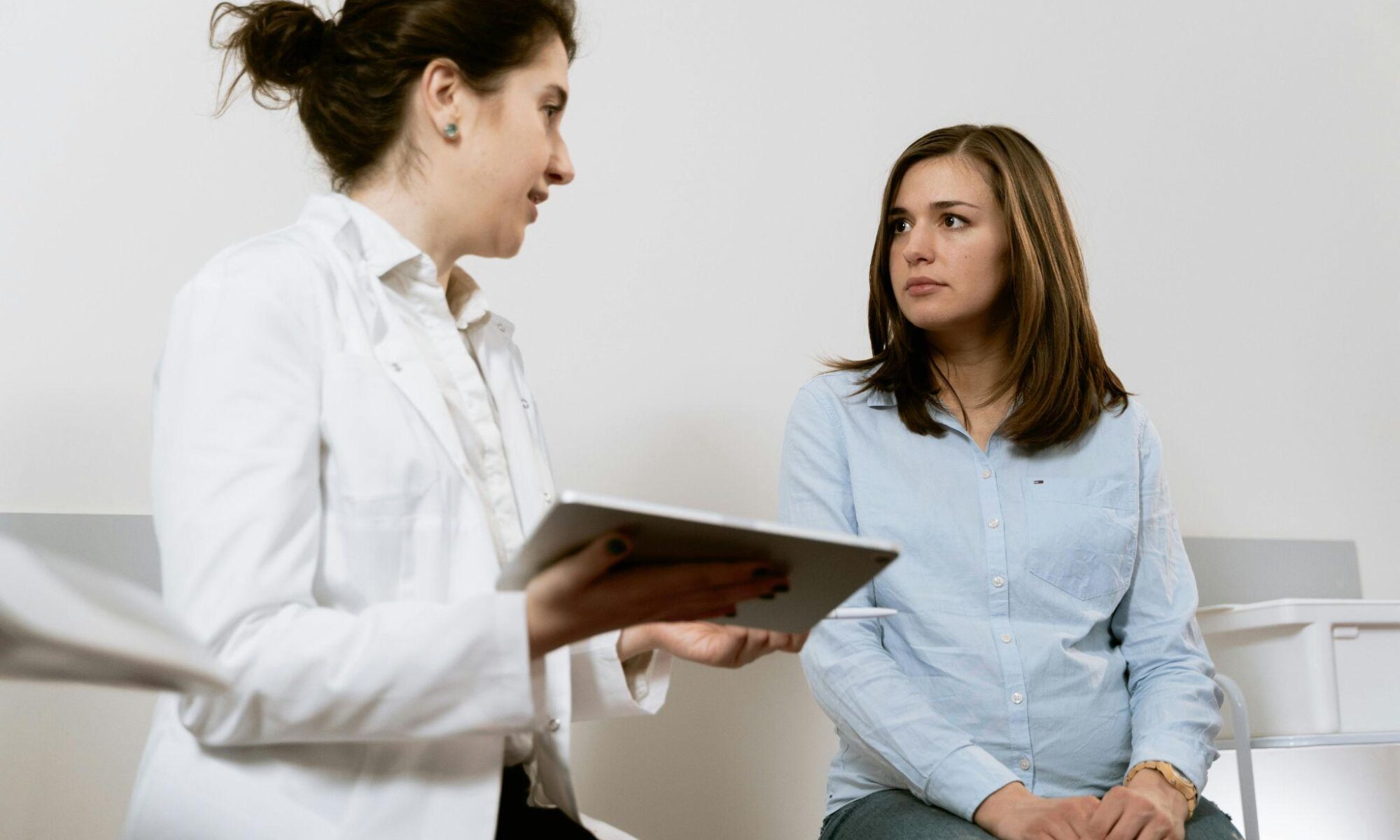 Woman at doctor for thyroid symptoms